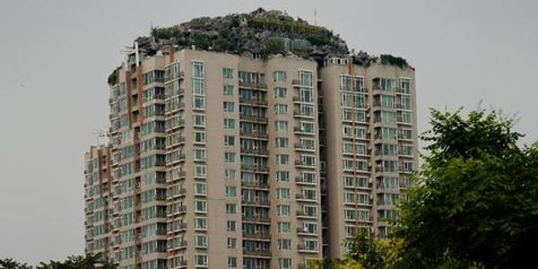 La maison est située sur une colline artificielle construite au sommet d'un gratte-ciel dont les autorités de Pékin ont ordonné la destruction.
